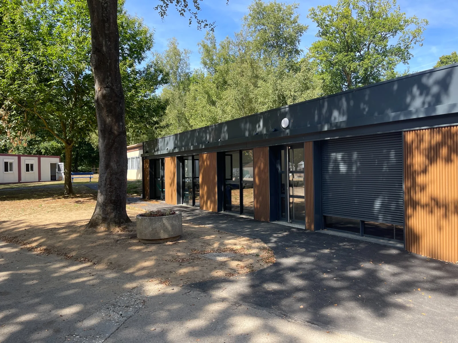 Façade du centre de loisirs modulaire de Bolbec avec bardage aspect bois, portes et fenêtres